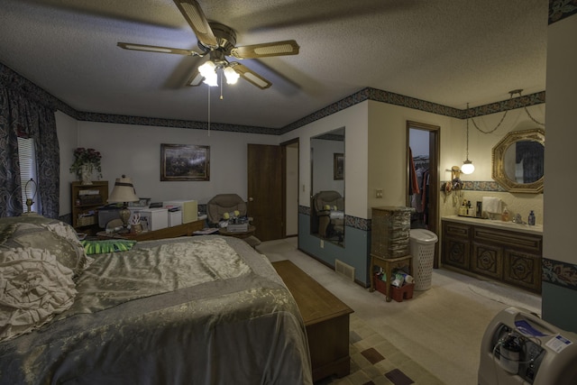 bedroom featuring light colored carpet, a textured ceiling, and visible vents