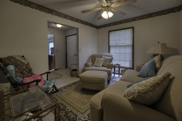 living area featuring a ceiling fan and tile patterned floors