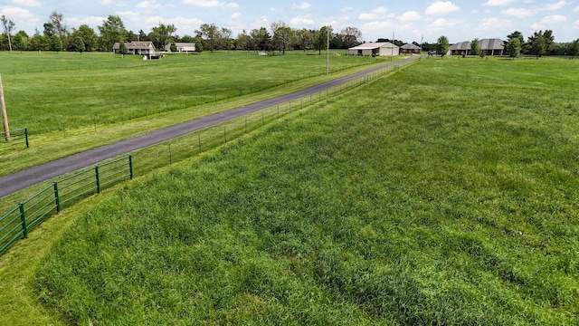 view of yard featuring a rural view and fence