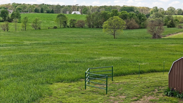 surrounding community featuring a lawn and a rural view