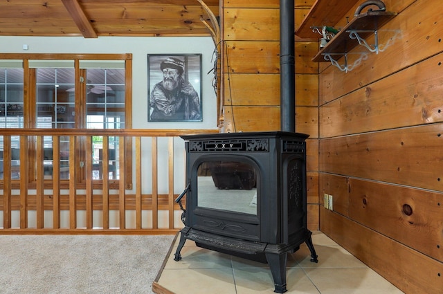 room details with a wood stove and beam ceiling
