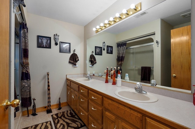 bathroom featuring visible vents, a sink, a shower with shower curtain, tile patterned floors, and double vanity