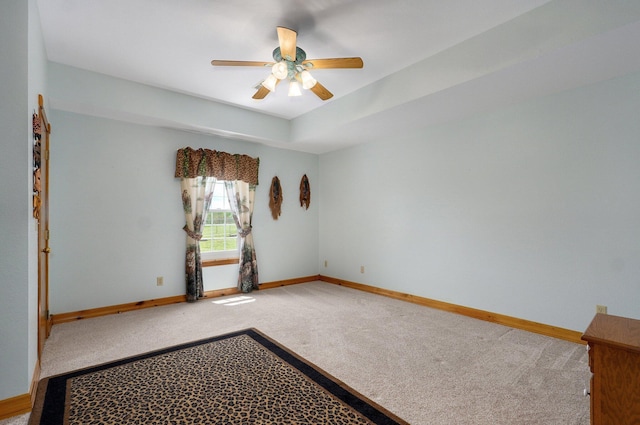 spare room featuring baseboards, carpet flooring, and ceiling fan