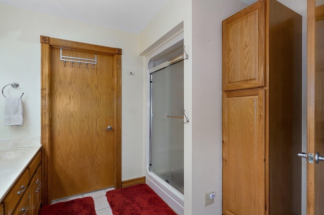 bathroom featuring a stall shower, tile patterned flooring, and vanity