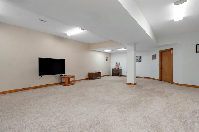 finished basement with carpet floors, baseboards, and visible vents