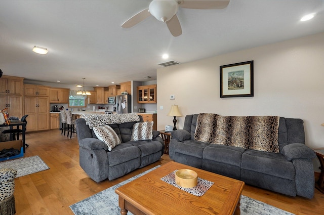 living area with light wood-type flooring, ceiling fan, recessed lighting, and visible vents