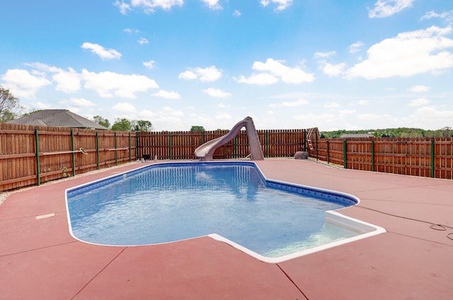 view of swimming pool featuring a water slide, a fenced backyard, a patio area, and a fenced in pool