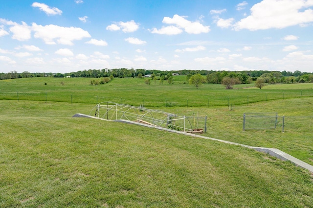 view of yard featuring a rural view and fence