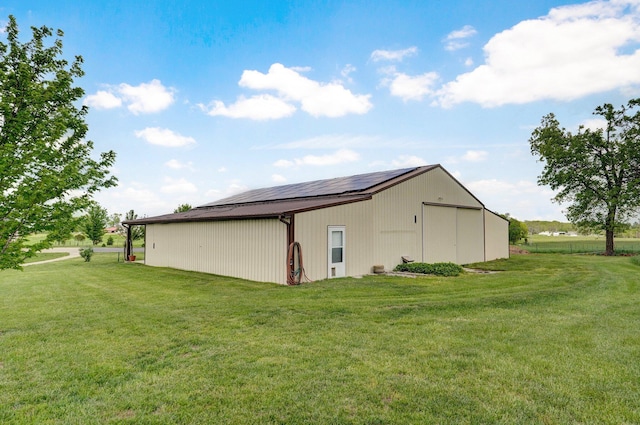 view of side of home featuring a lawn, an outbuilding, and an outdoor structure