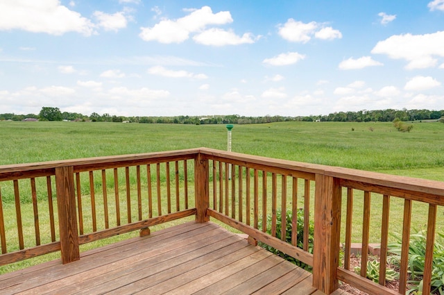 deck featuring a yard and a rural view