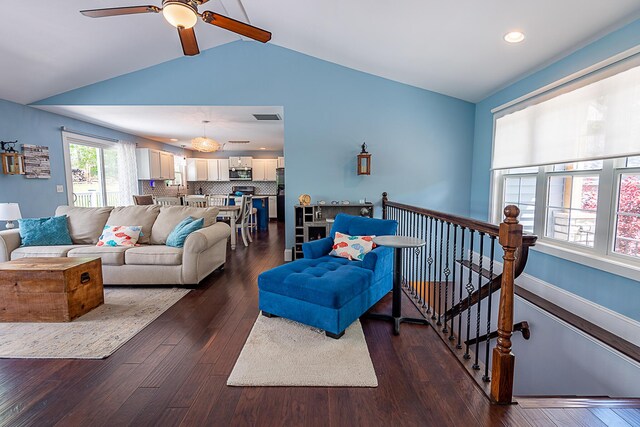 living area featuring lofted ceiling, ceiling fan, dark wood-type flooring, and recessed lighting