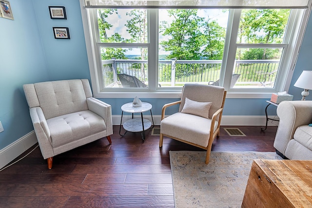 sitting room with baseboards and wood finished floors