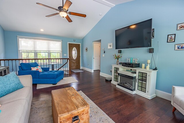 living area with ceiling fan, vaulted ceiling, dark wood-type flooring, and baseboards