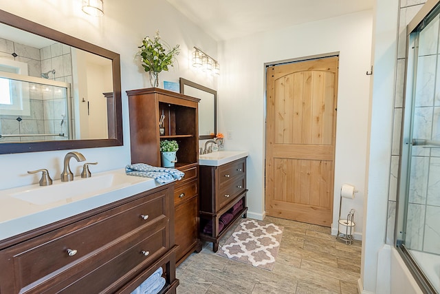 full bathroom with two vanities and baseboards