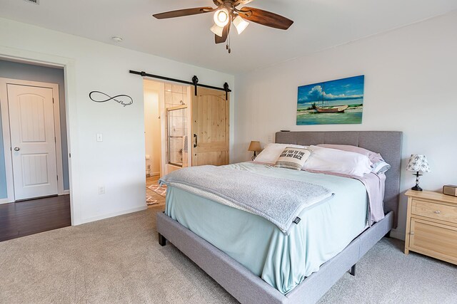 bedroom featuring carpet, a barn door, baseboards, and ceiling fan