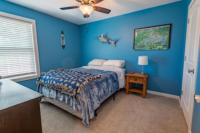 carpeted bedroom with baseboards and ceiling fan