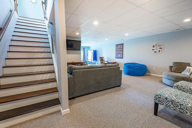 living area with carpet flooring, stairs, recessed lighting, baseboards, and a paneled ceiling
