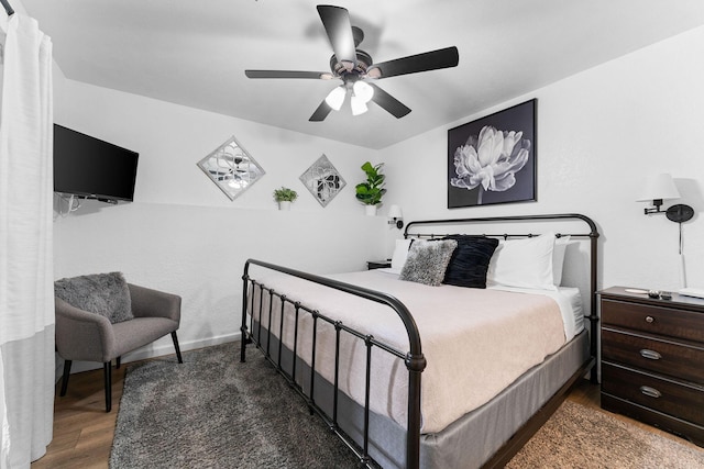 bedroom featuring baseboards, ceiling fan, and wood finished floors