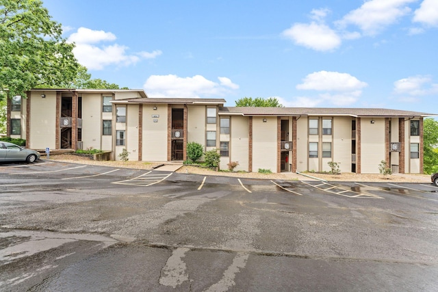 view of property with uncovered parking