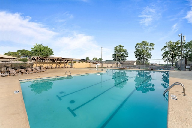 pool featuring a patio and fence