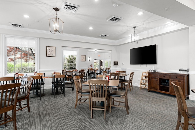 carpeted dining room featuring ornamental molding and visible vents