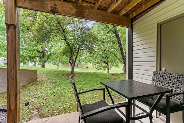 sunroom / solarium featuring outdoor dining space