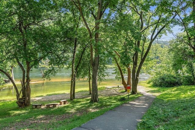 view of community with a lawn and a water view