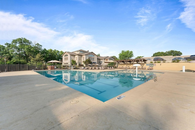 pool with fence and a patio area