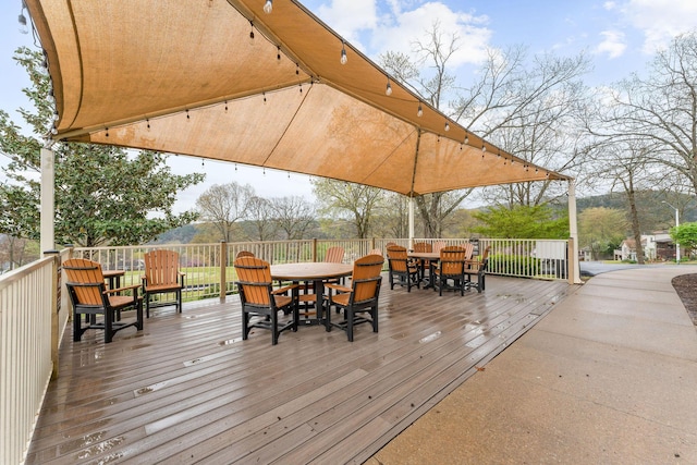 wooden terrace featuring outdoor dining space