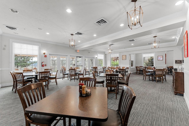 carpeted dining space featuring an inviting chandelier, ornamental molding, recessed lighting, and visible vents