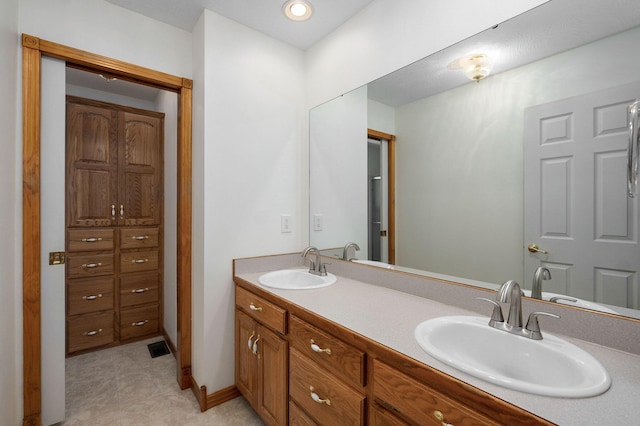 full bath with double vanity and a sink