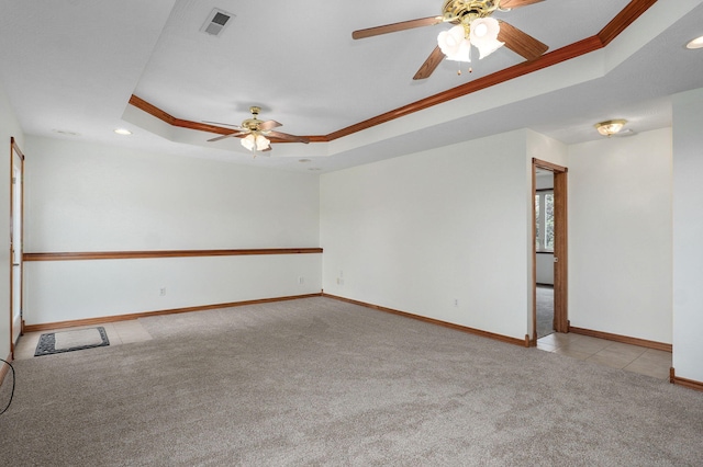 carpeted spare room featuring ornamental molding, baseboards, recessed lighting, a raised ceiling, and a ceiling fan