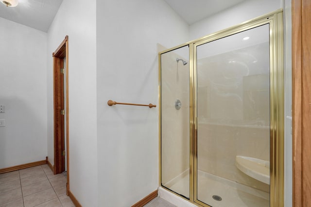 full bath with baseboards, tile patterned floors, and a stall shower