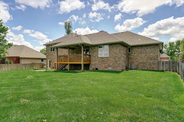 back of house featuring a yard, ceiling fan, central AC unit, and a fenced backyard