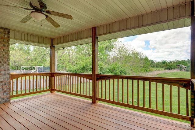 deck with a lawn and a ceiling fan
