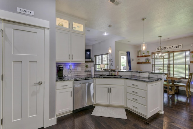 kitchen featuring backsplash, visible vents, stainless steel dishwasher, a peninsula, and dark wood-style floors