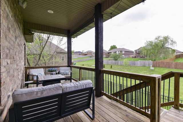 deck with a lawn, an outdoor living space, a residential view, and a fenced backyard