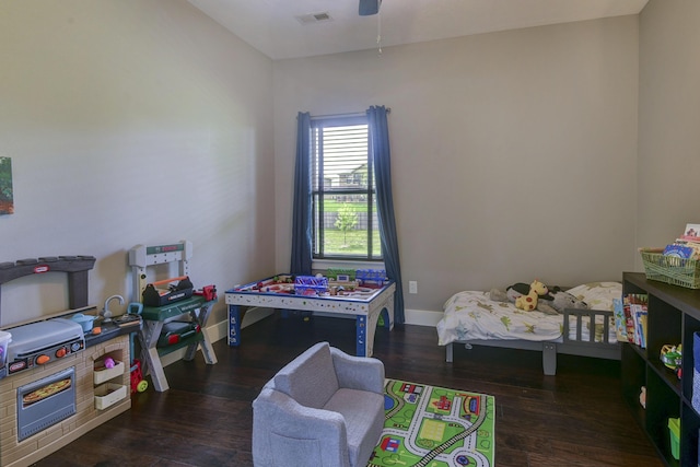 bedroom with baseboards, a ceiling fan, wood finished floors, and visible vents