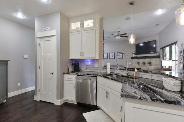kitchen with a sink, tasteful backsplash, stainless steel dishwasher, and dark wood-style flooring