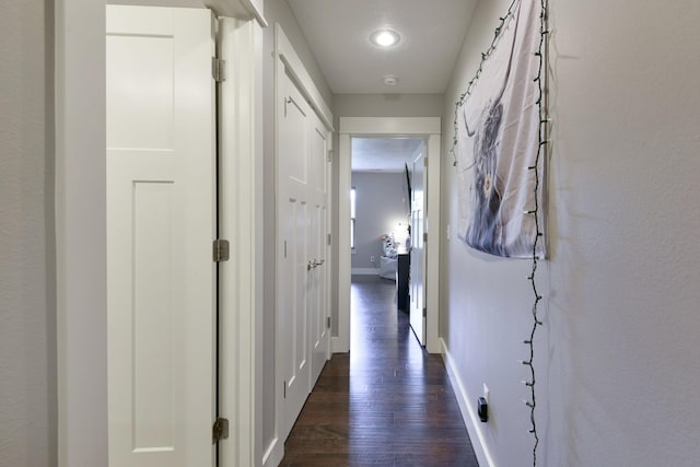 hall featuring baseboards, recessed lighting, and dark wood finished floors