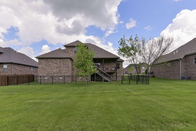 view of yard with a fenced backyard, a deck, and stairway