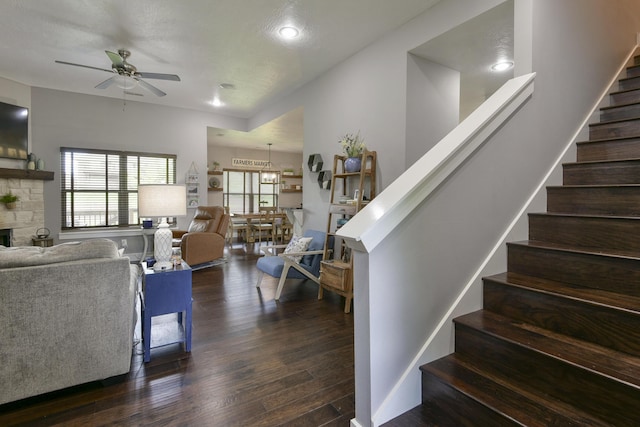 interior space featuring ceiling fan, a fireplace, recessed lighting, and wood finished floors