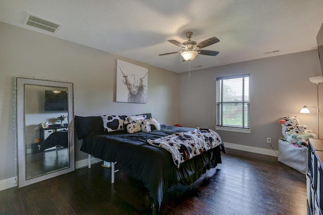 bedroom with visible vents, baseboards, and dark wood-style flooring
