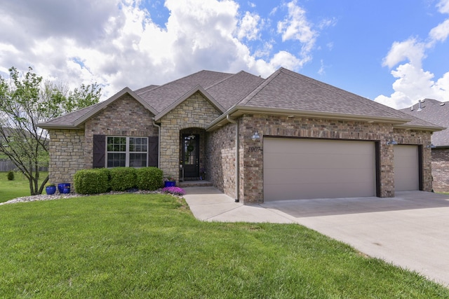 view of front of property with a shingled roof, a front lawn, stone siding, a garage, and concrete driveway