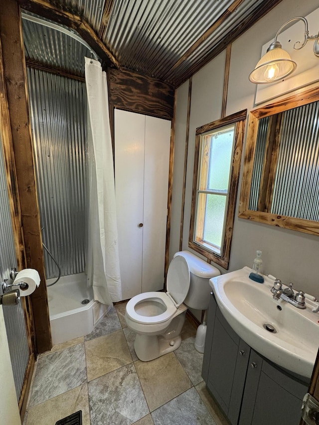 full bath with vanity, toilet, and a shower stall