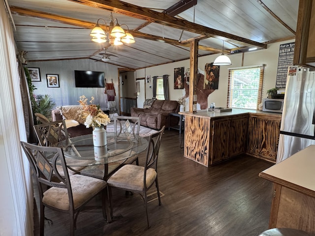 dining room featuring a chandelier, dark wood-style floors, vaulted ceiling, and a healthy amount of sunlight