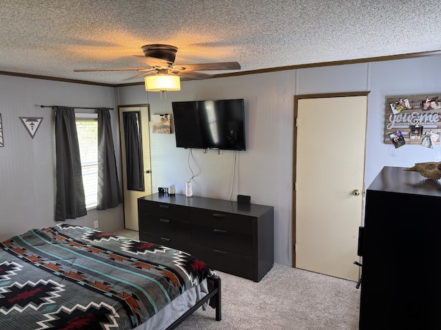 carpeted bedroom with crown molding, a textured ceiling, and ceiling fan