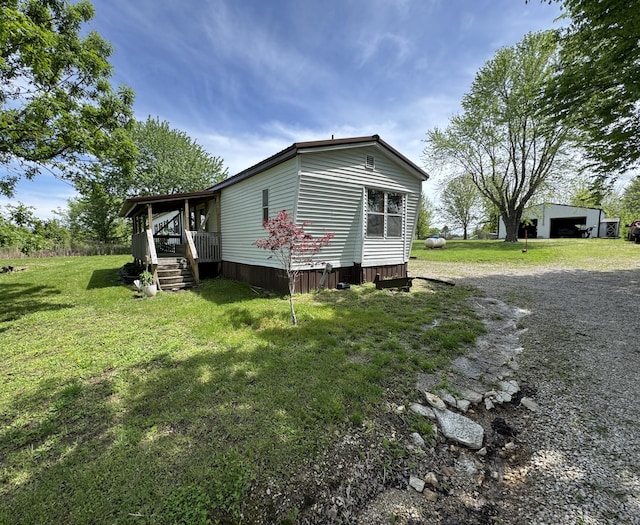 view of property exterior with a yard and an outbuilding