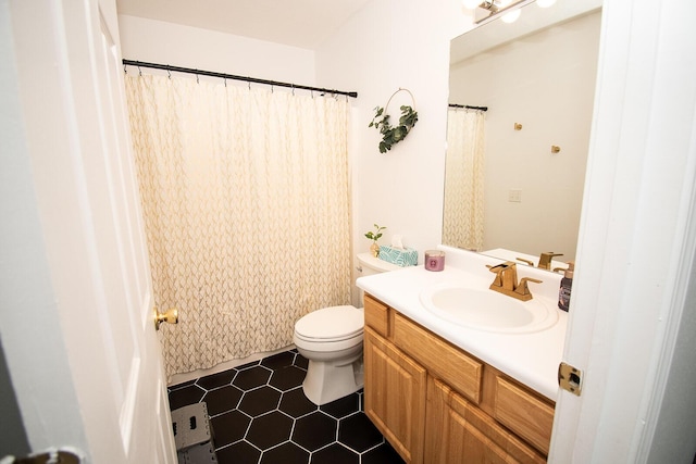 full bath with toilet, tile patterned flooring, and vanity