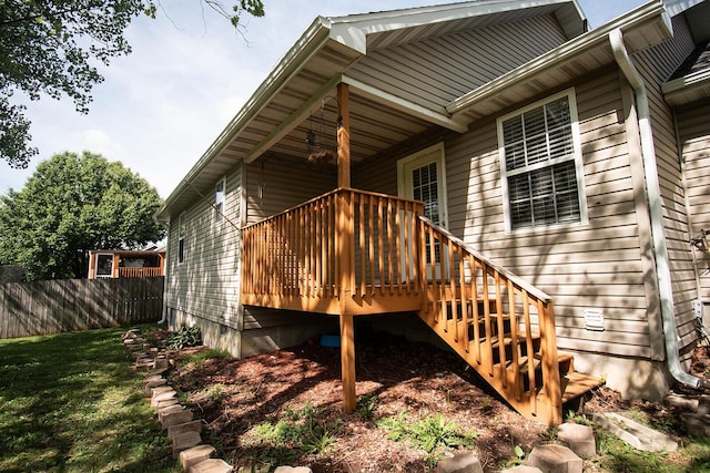 back of property featuring a wooden deck and fence
